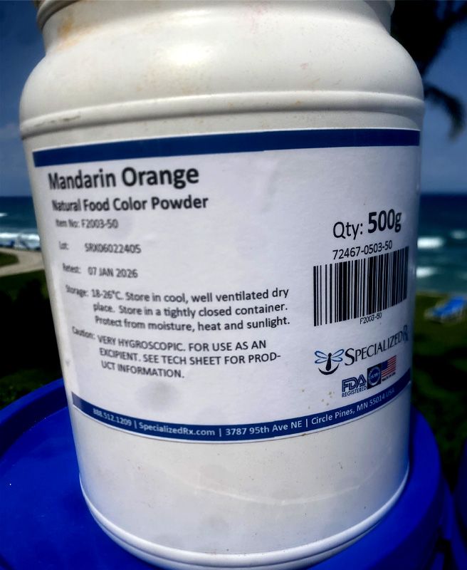 Roman - blue tub of mandarin orange powder