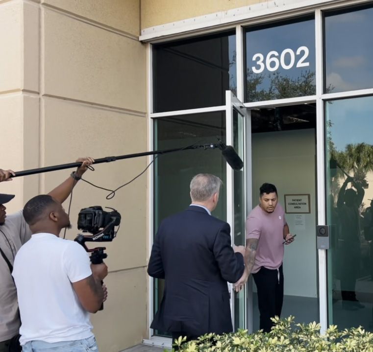 Chris Hansen interviews Roman employee outside office